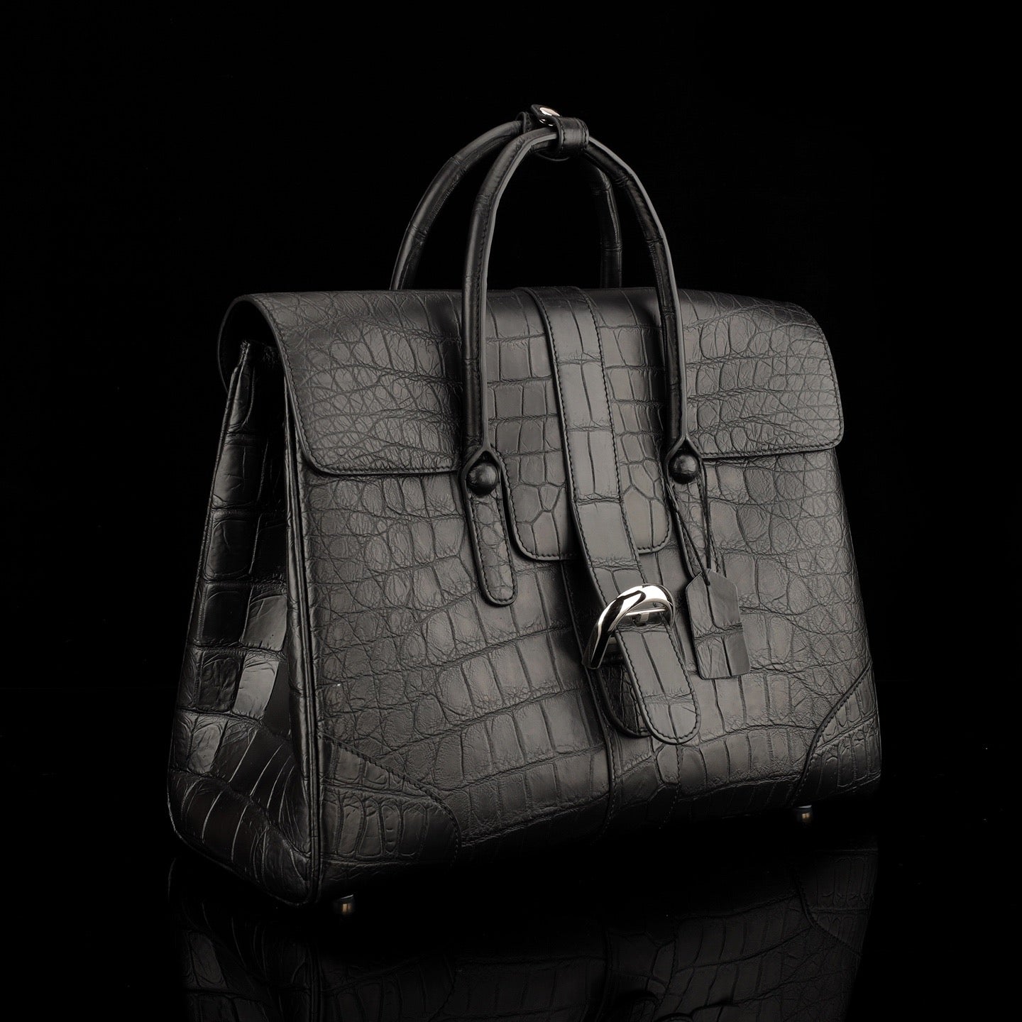 Black crocodile leather briefcase by Rossie Viren, featuring a sleek, textured exterior and sturdy handles for professional use.