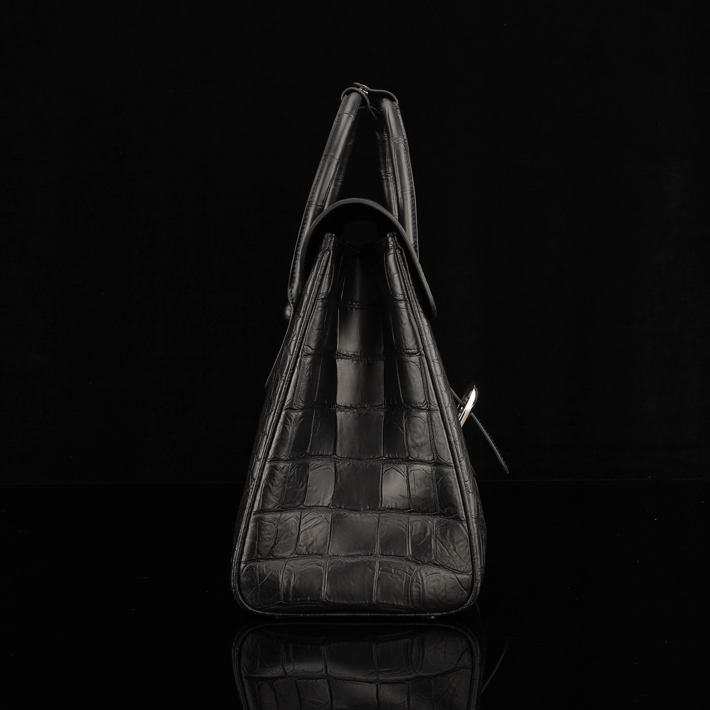 Black crocodile leather briefcase by Rossie Viren with sturdy handles and sleek design, ideal for professional use.