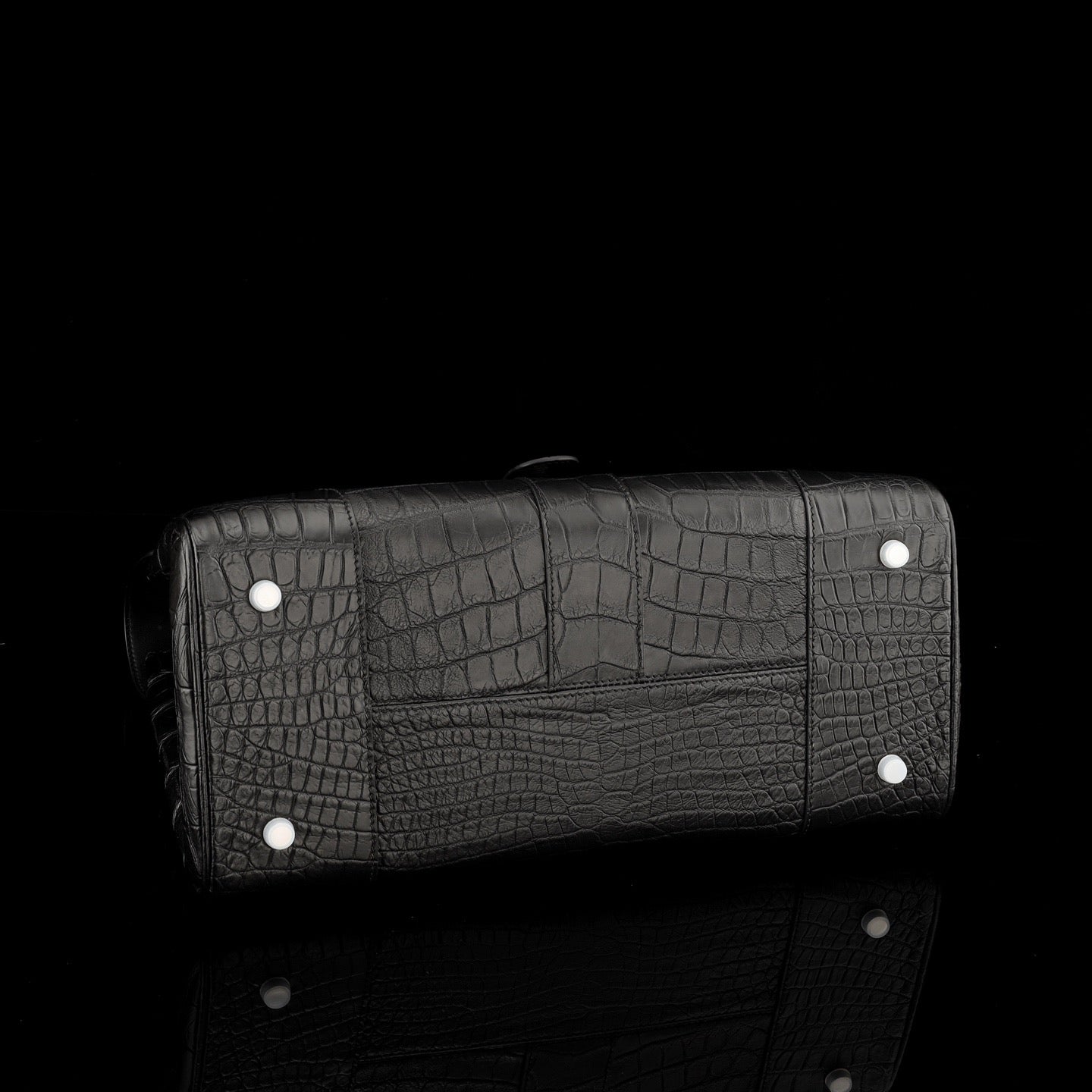 Black crocodile leather briefcase by Rossie Viren with sturdy handles, textured crocodile pattern, and polished finish.