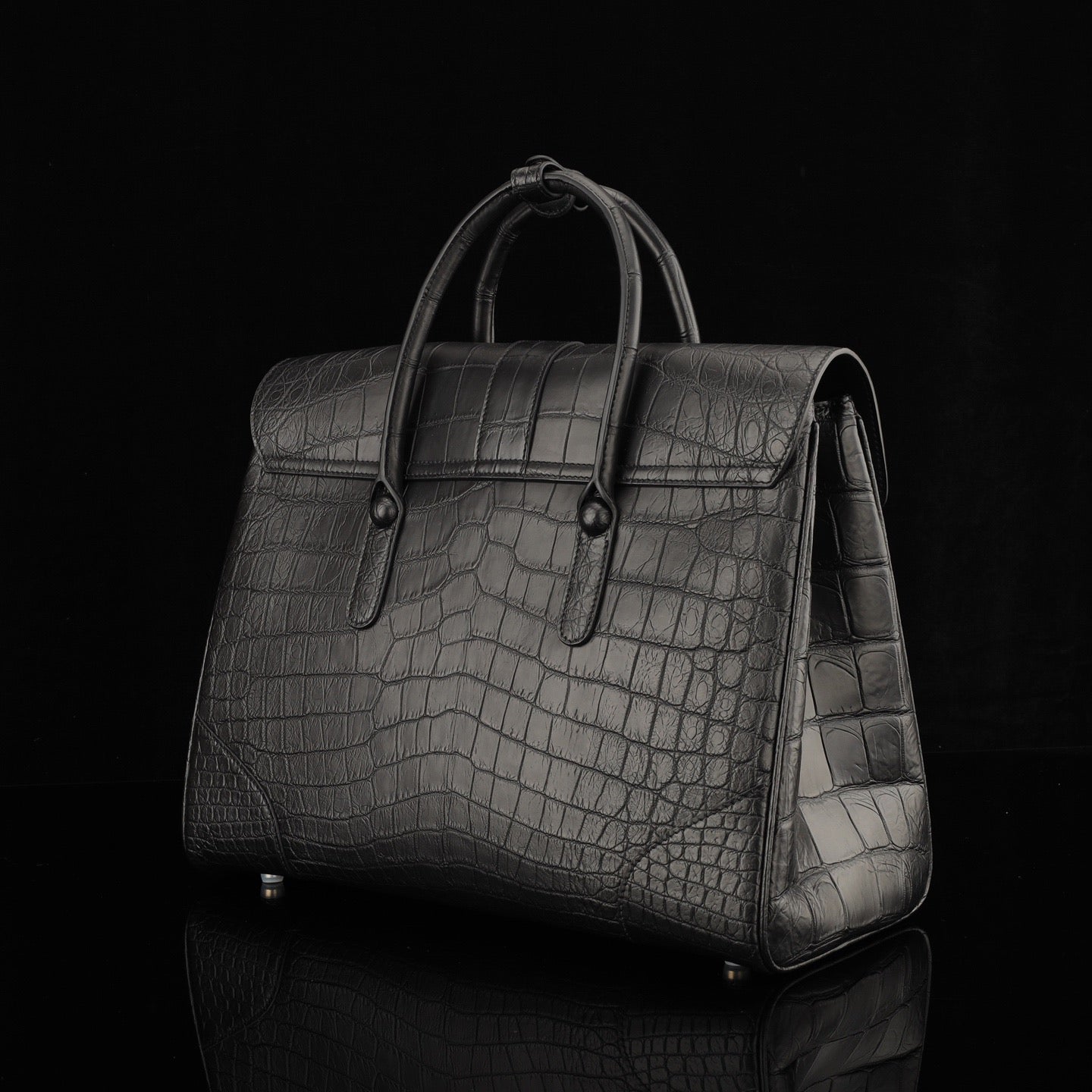Black crocodile leather briefcase by Rossie Viren, featuring a sleek design with sturdy handles and textured crocodile pattern.