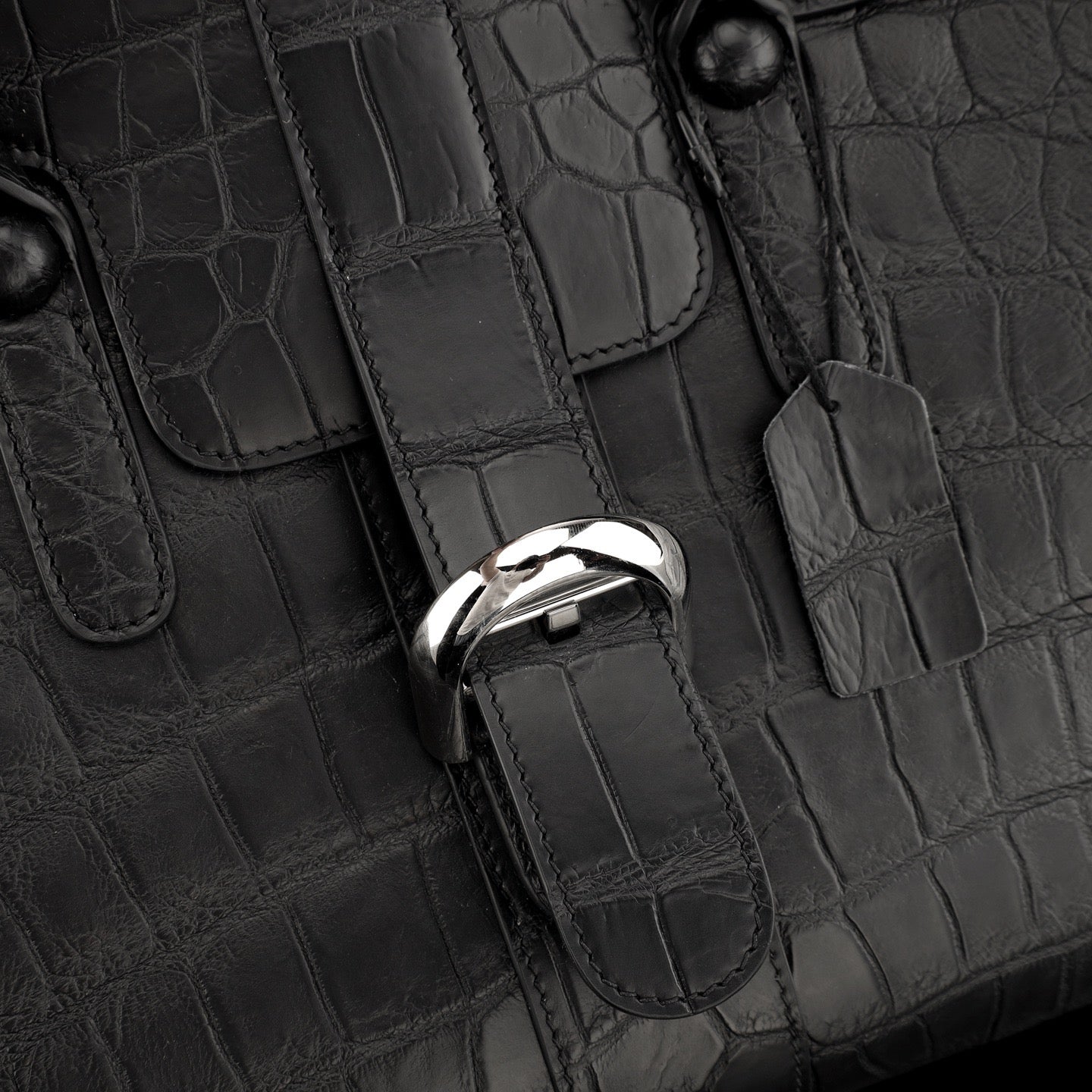 Black crocodile leather briefcase by Rossie Viren with sturdy handle and sleek design, showcasing textured crocodile pattern.