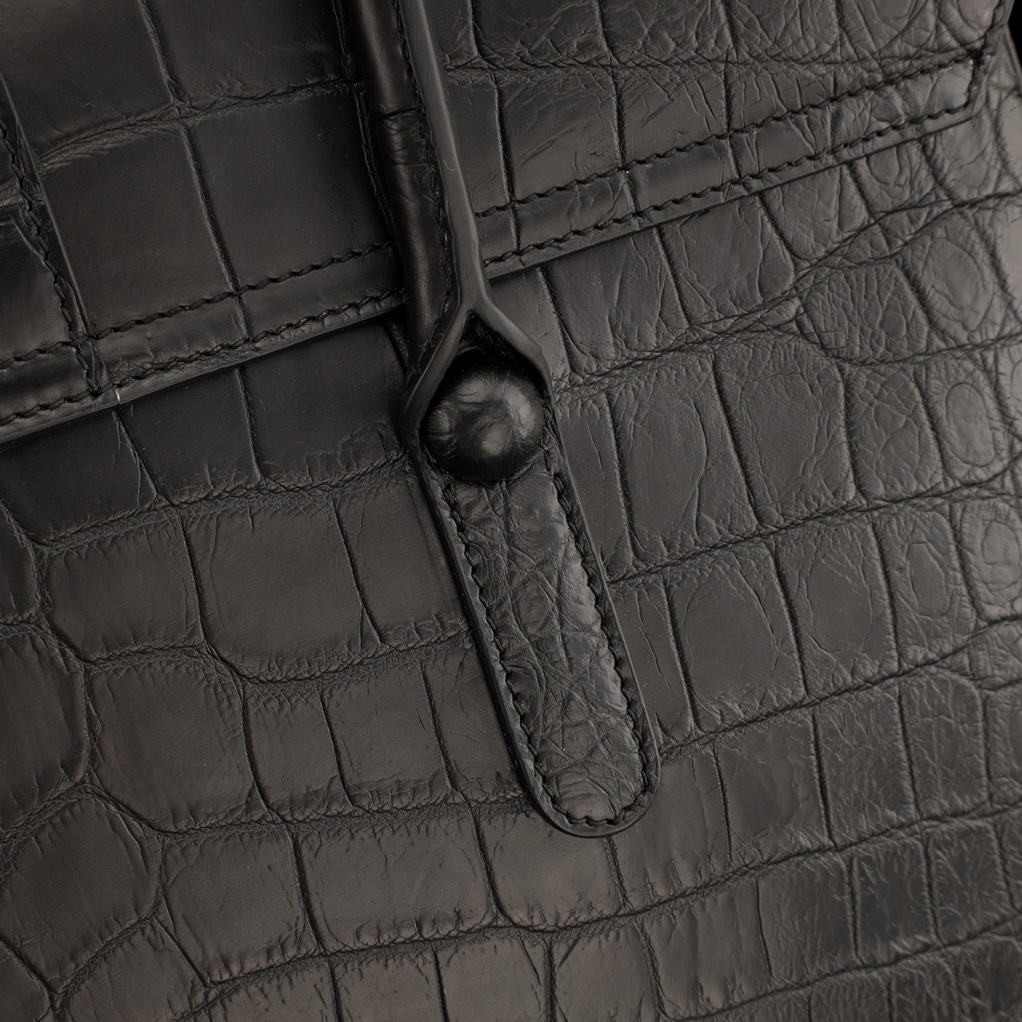 Black crocodile leather briefcase by Rossie Viren, featuring a structured design with sturdy handles and a polished finish.