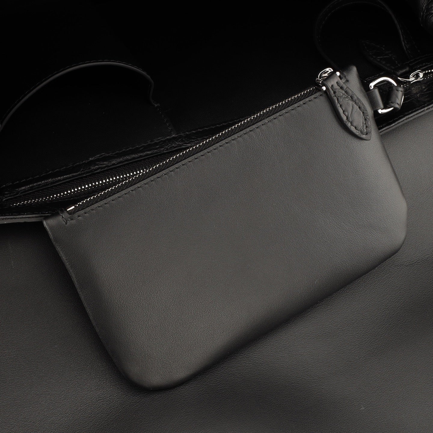 Black crocodile leather briefcase by Rossie Viren with sturdy handles and polished metal accents.