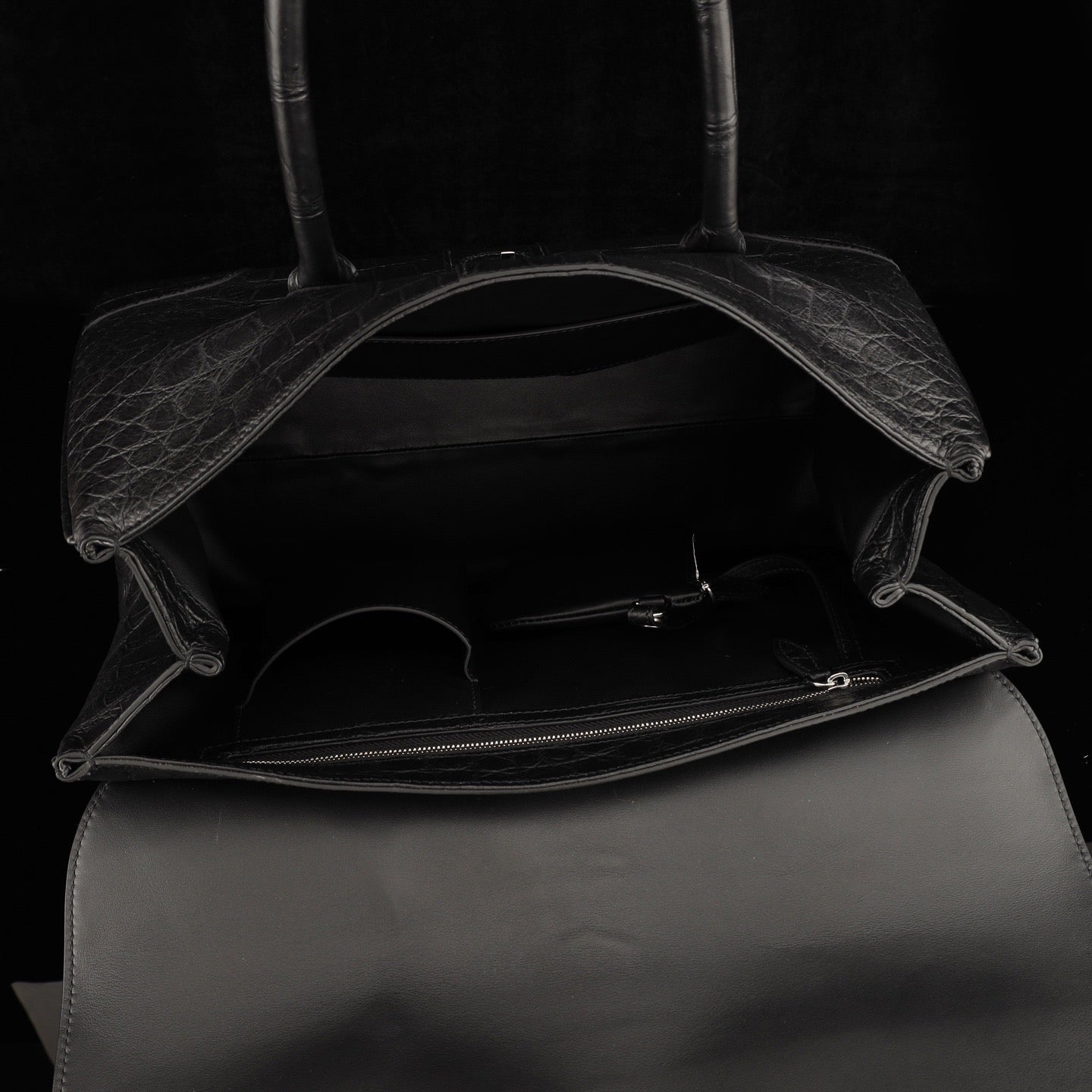 Black crocodile leather briefcase by Rossie Viren with sturdy handle and sleek design, perfect for professional use.