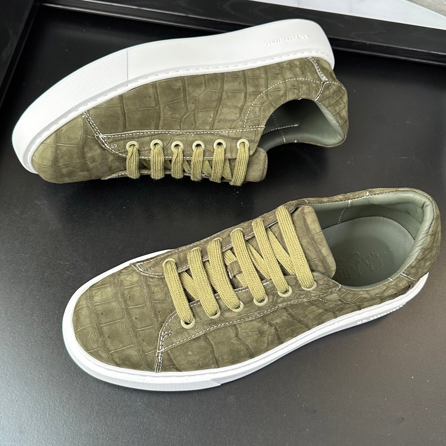 Green Rossie Viren Crocodile Sneakers made of genuine nubuck crocodile leather, featuring a stylish and textured shoe design.