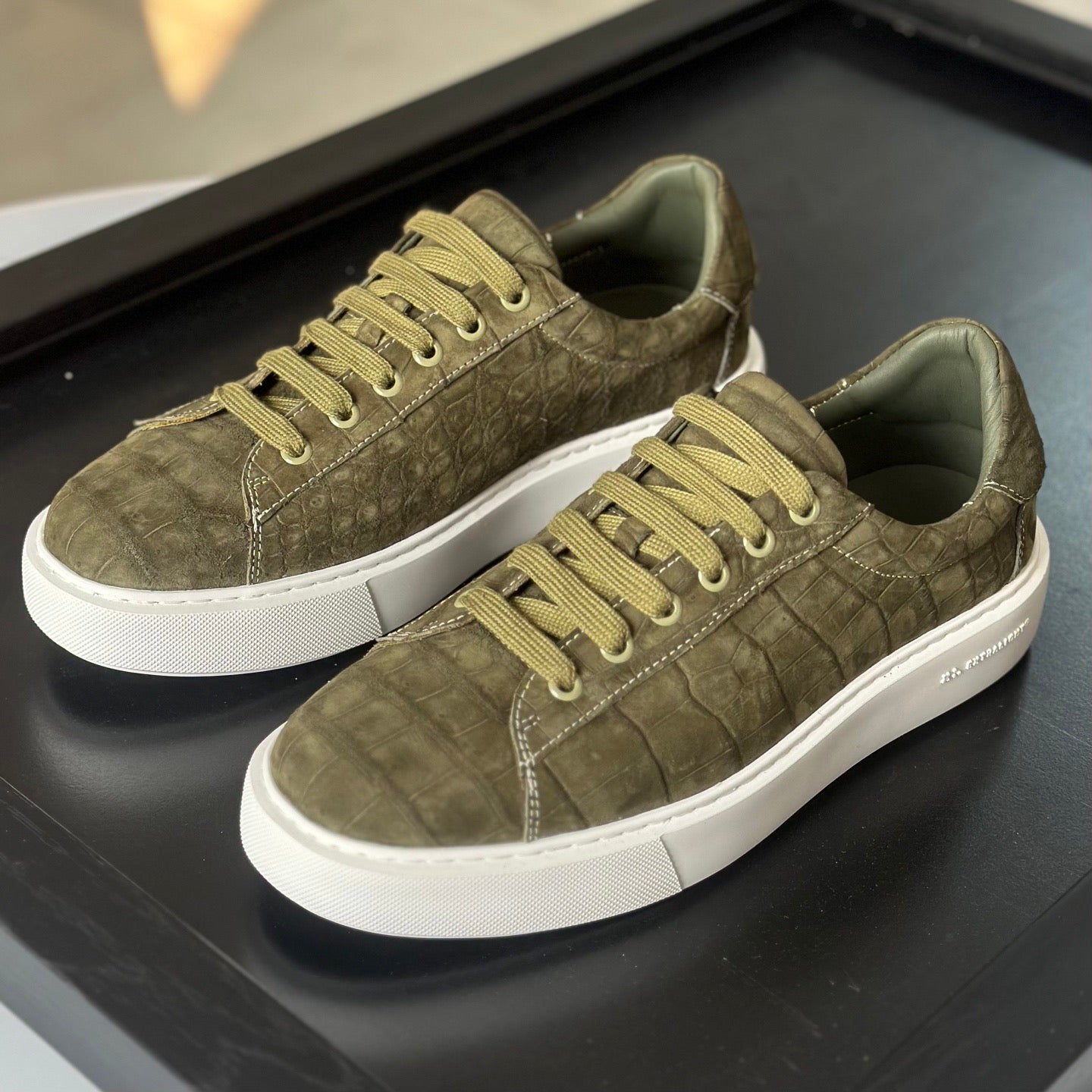 Green Rossie Viren crocodile sneakers made from genuine nubuck crocodile leather, stylish shoes with textured crocodile pattern.