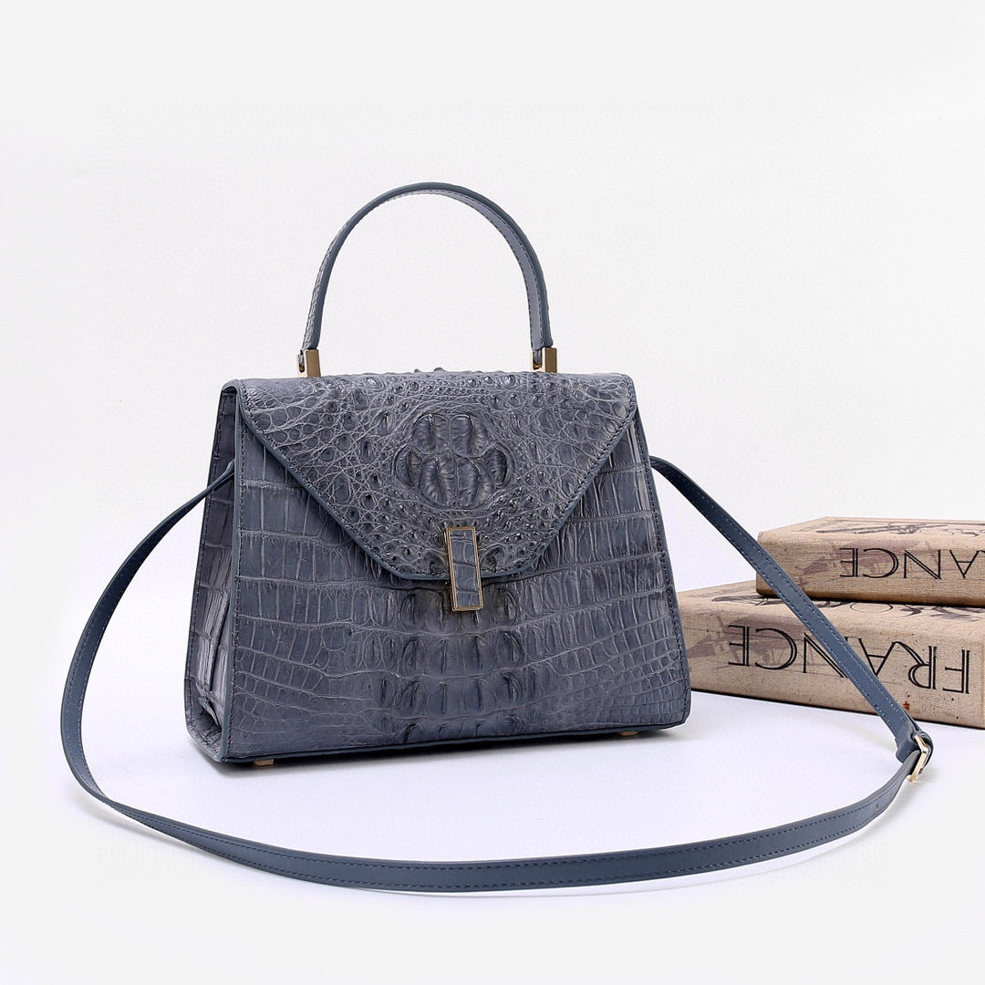 Genuine crocodile skin bone leather top handle bag in grey by Rossie Viren, featuring a sleek design and structured silhouette.