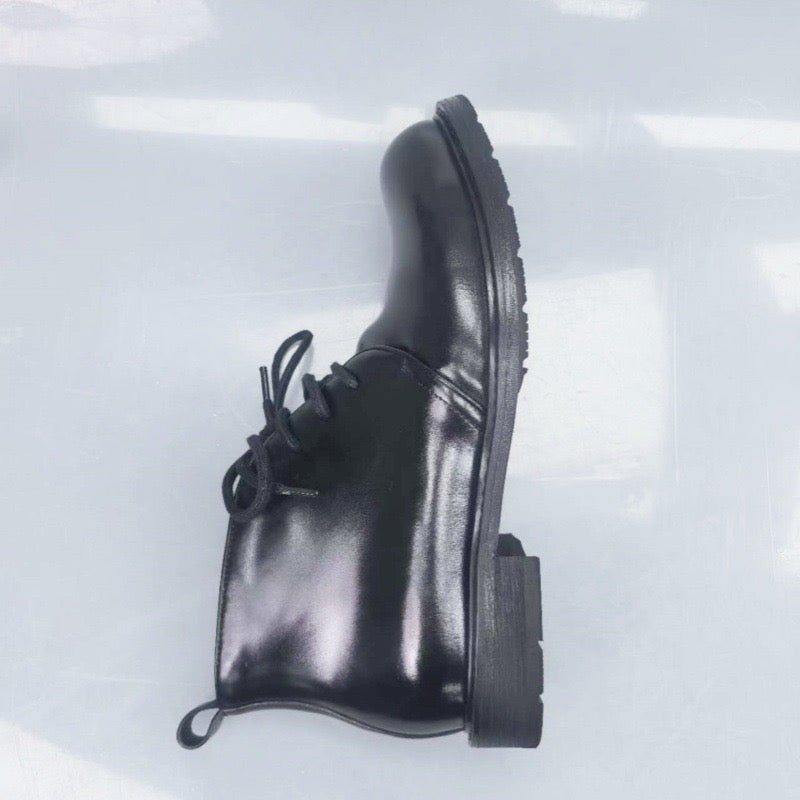 Genuine Shell Cordovan leather short lace-up Martin boots by Rossie Viren, featuring sleek black leather and sturdy soles.