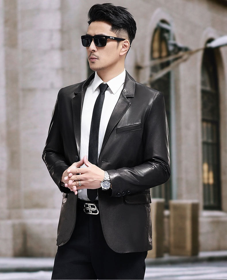 Black leather blazer jacket by Rossie Viren, featuring a tailored fit and classic design, shown on a hanger.