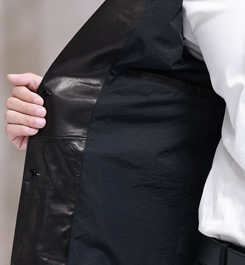 Black leather blazer jacket by Rossie Viren, tailored fit with structured design and classic lapel, displayed on a hanger.