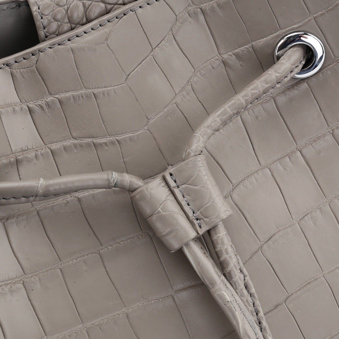 Unisex crocodile leather drawstring bucket shoulder bag by Rossie Viren with large capacity and crossbody design.