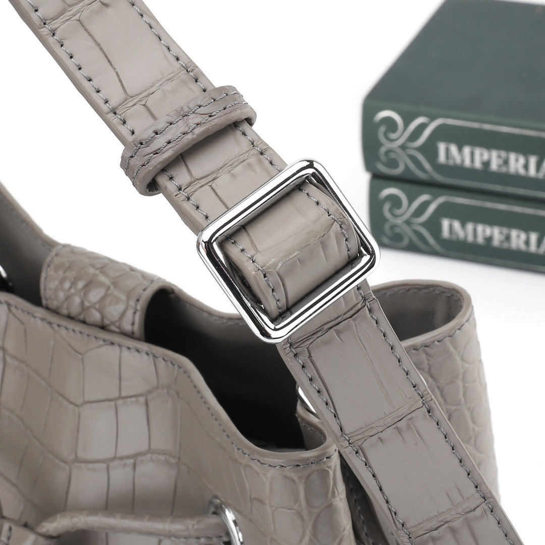 Unisex crocodile leather drawstring bucket shoulder bag with crossbody strap, large capacity, by Rossie Viren.