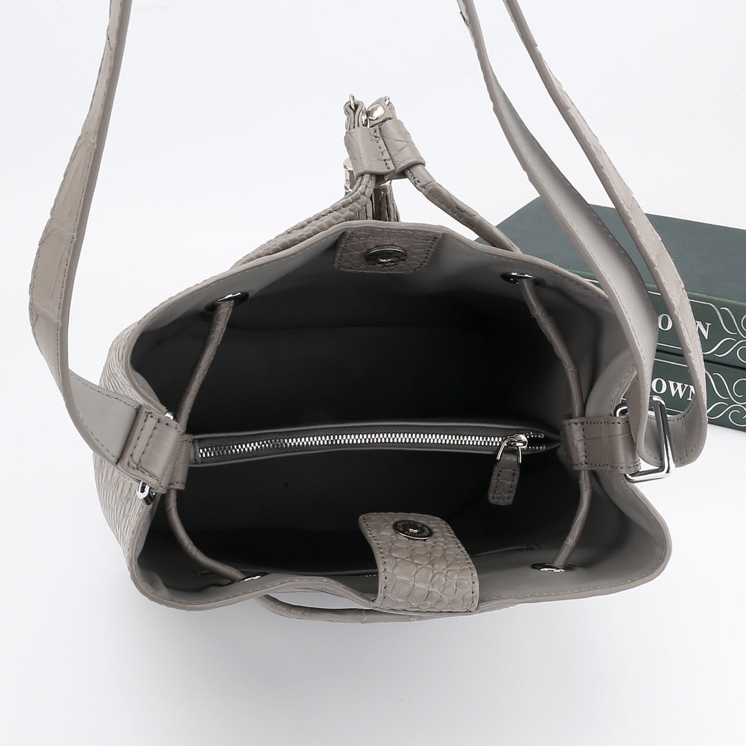 Unisex crocodile leather drawstring bucket shoulder bag with crossbody strap, large capacity, by Rossie Viren.