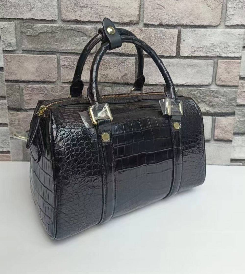 Black crocodile leather top handle Boston crossbody handbag by Rossie Viren with structured design and gold-tone hardware.