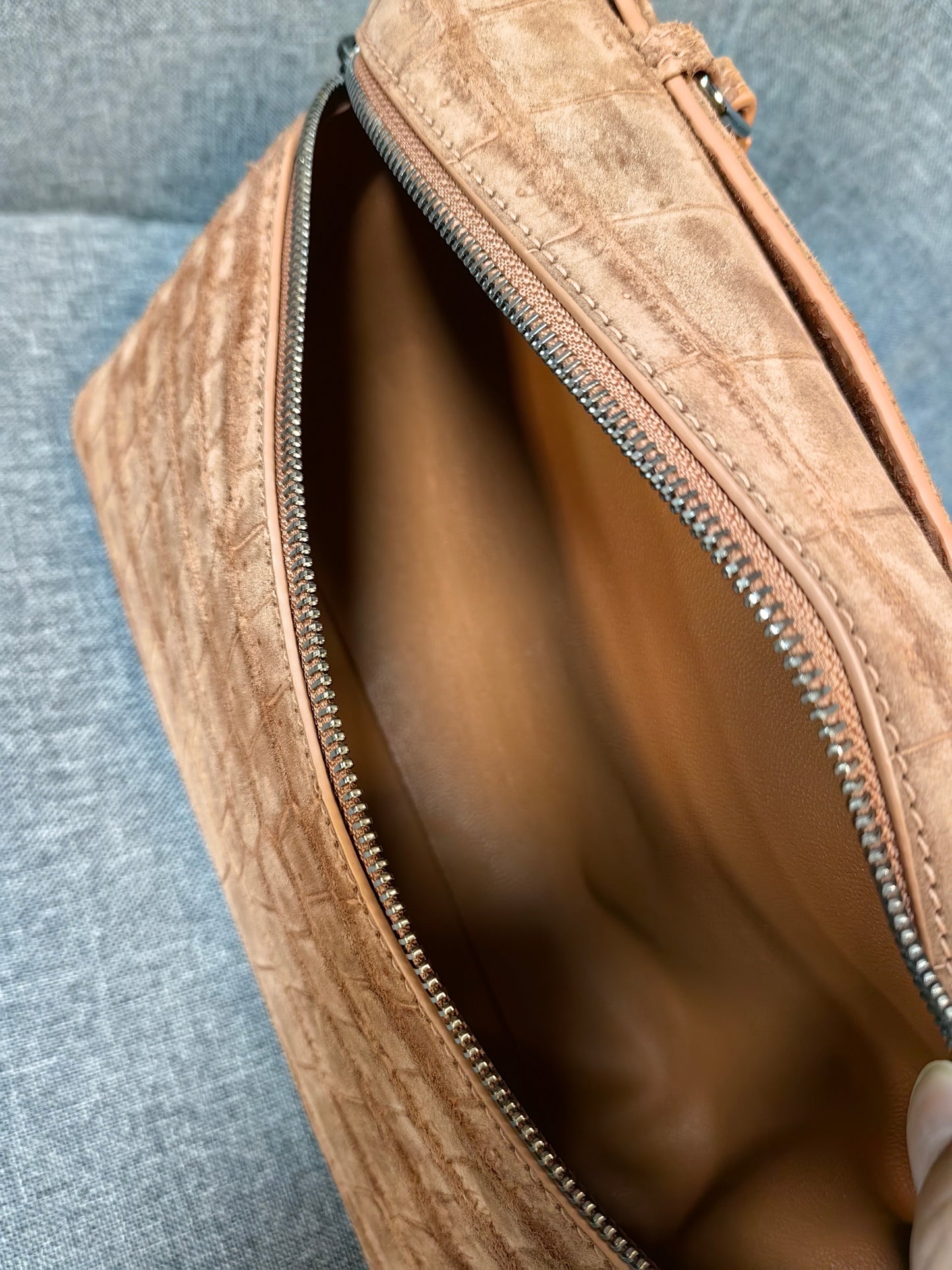 Unisex Rossie Viren leather clutch bag with crocodile skin texture, zipper handle, and nubuck finish, suitable for stylish carry.