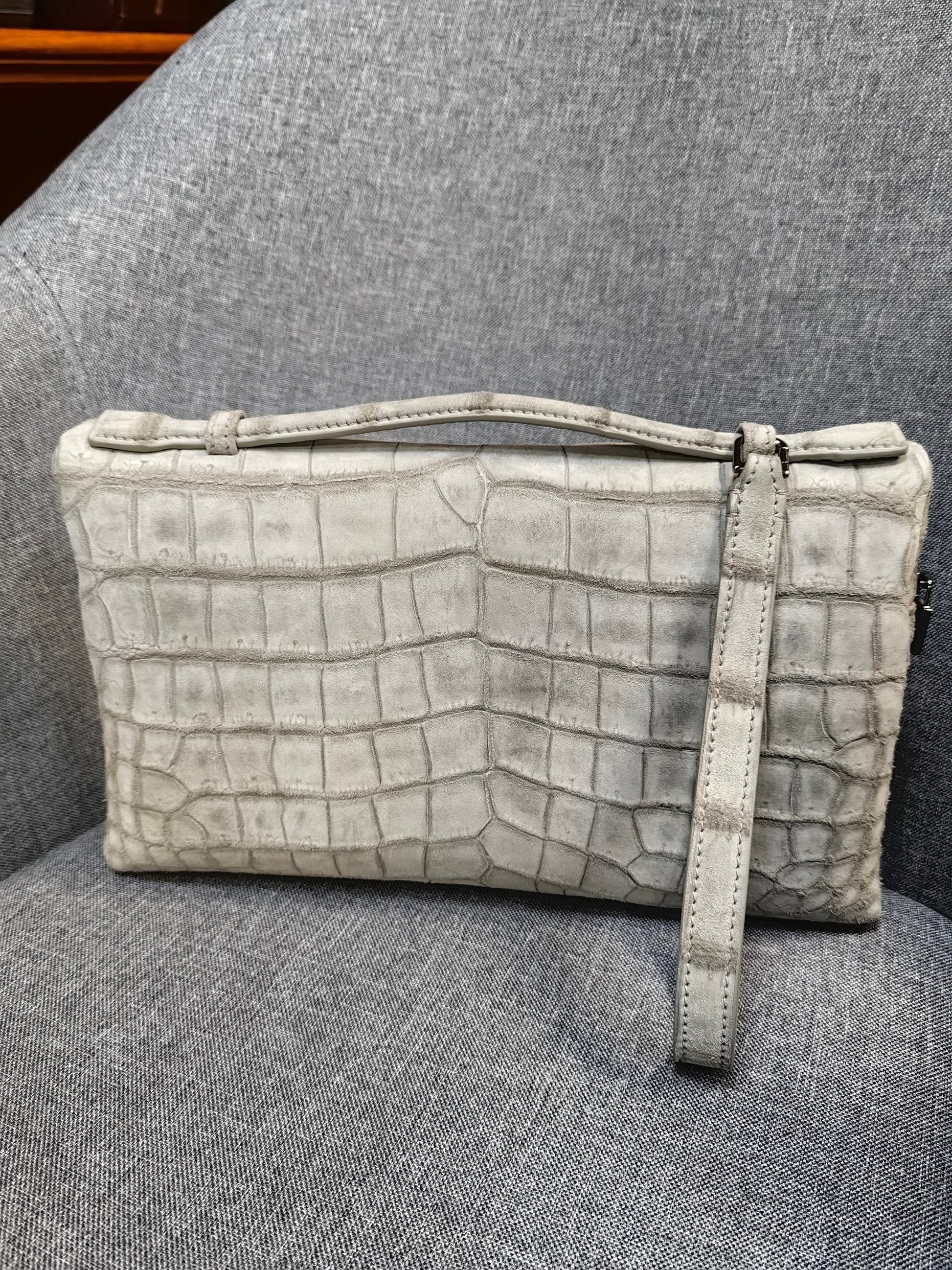 Unisex Rossie Viren leather clutch bag with crocodile skin texture and zipper handle, made from genuine nubuck crocodile leather.