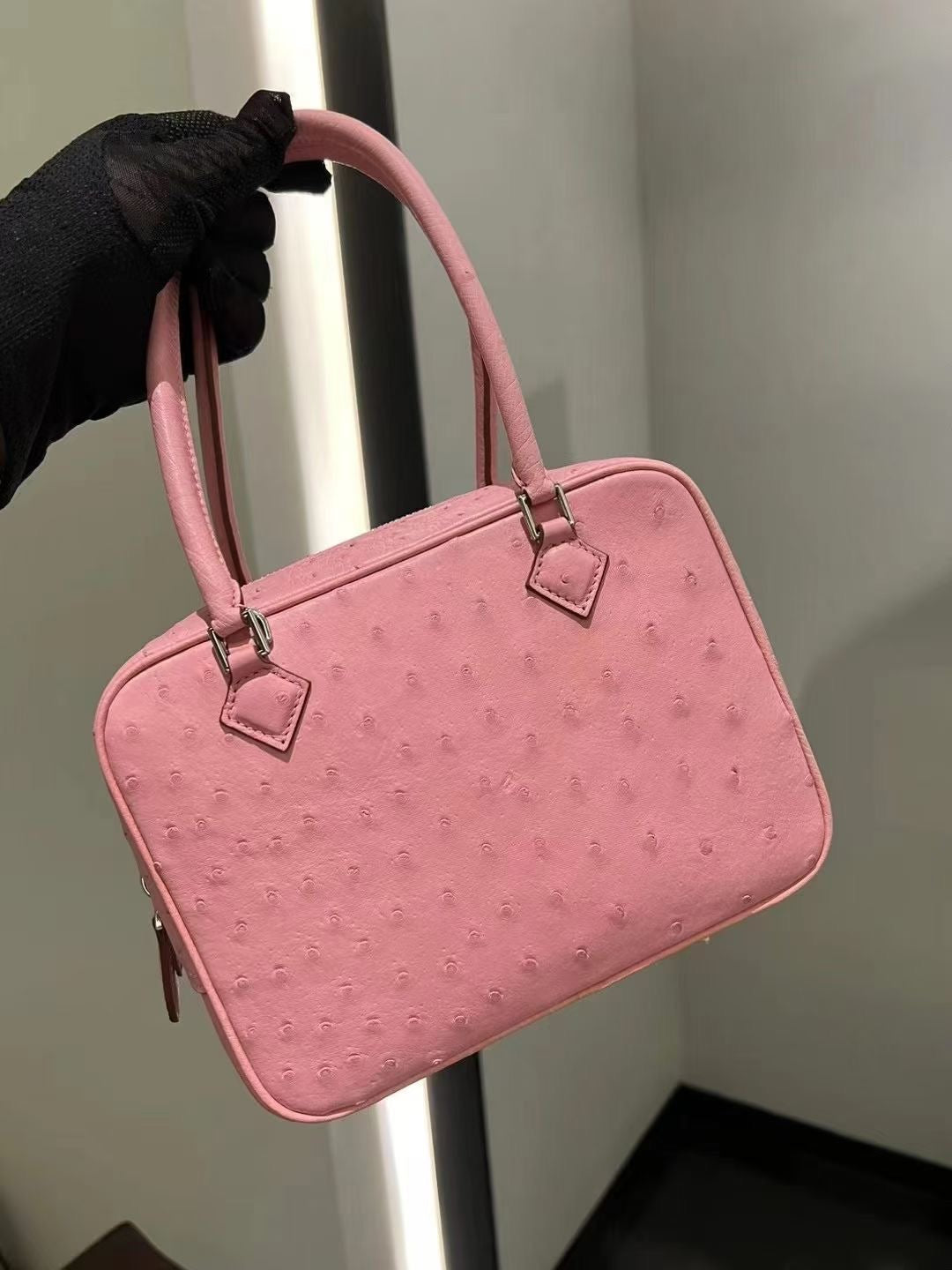 Women's genuine ostrich skin leather handbag with top handle by Rossie Viren, featuring a sleek and stylish design.