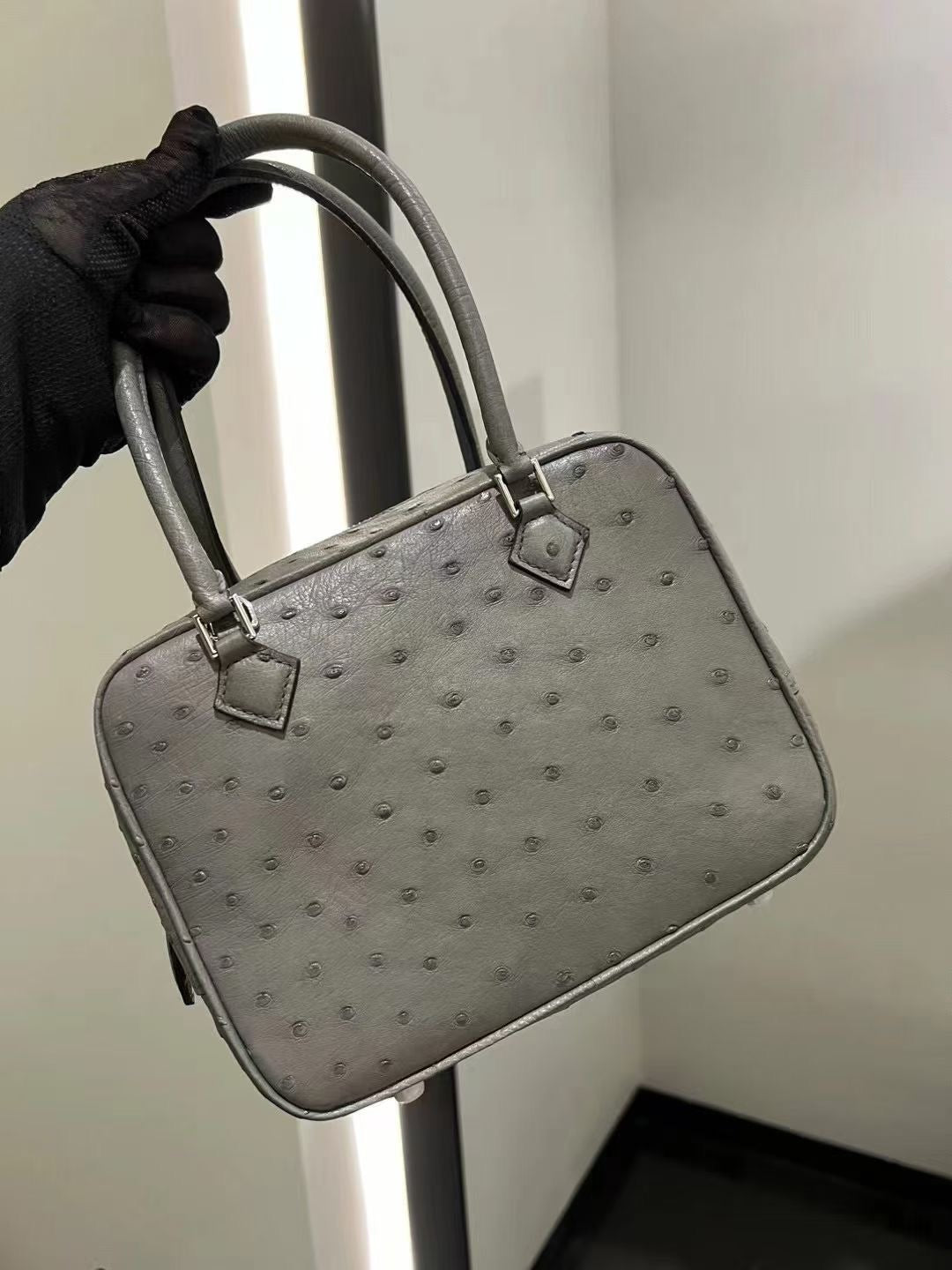 Rossie Viren women's genuine ostrich skin leather handbag with top handle, showcasing its textured surface and elegant design.