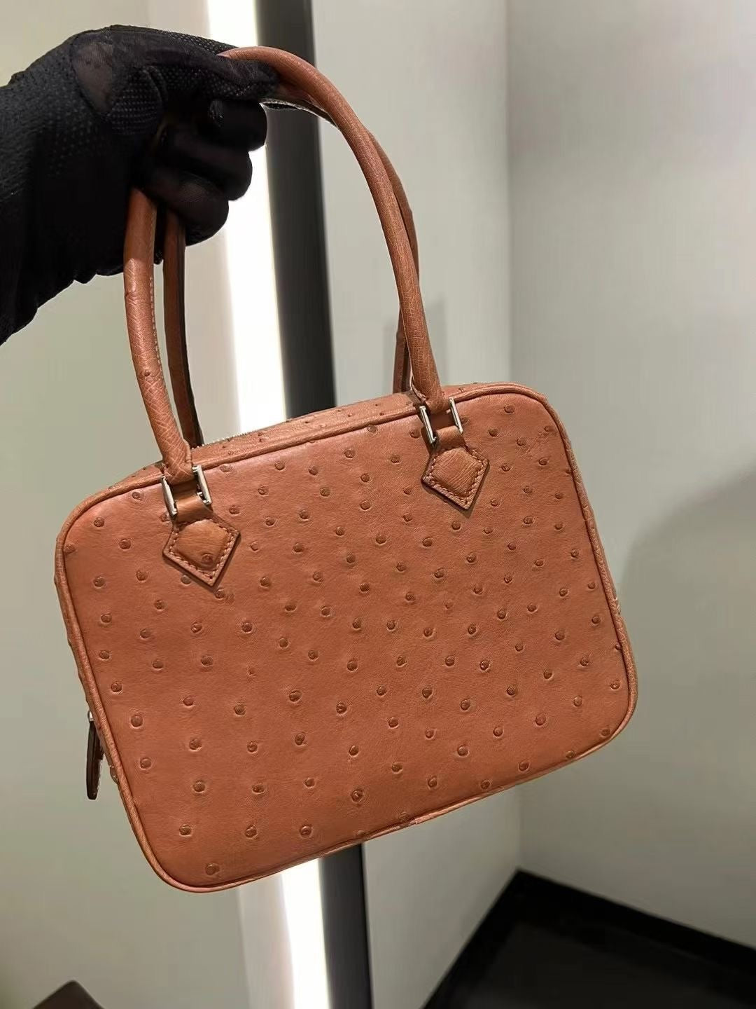 Women's genuine ostrich skin leather handbag with top handle by Rossie Viren, showcasing textured ostrich leather and elegant design.