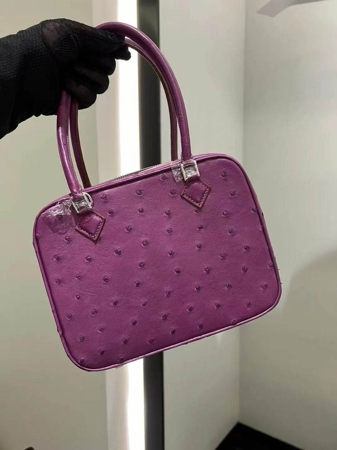 Women's genuine ostrich skin leather handbag with top handle by Rossie Viren, featuring a stylish and textured leather design.