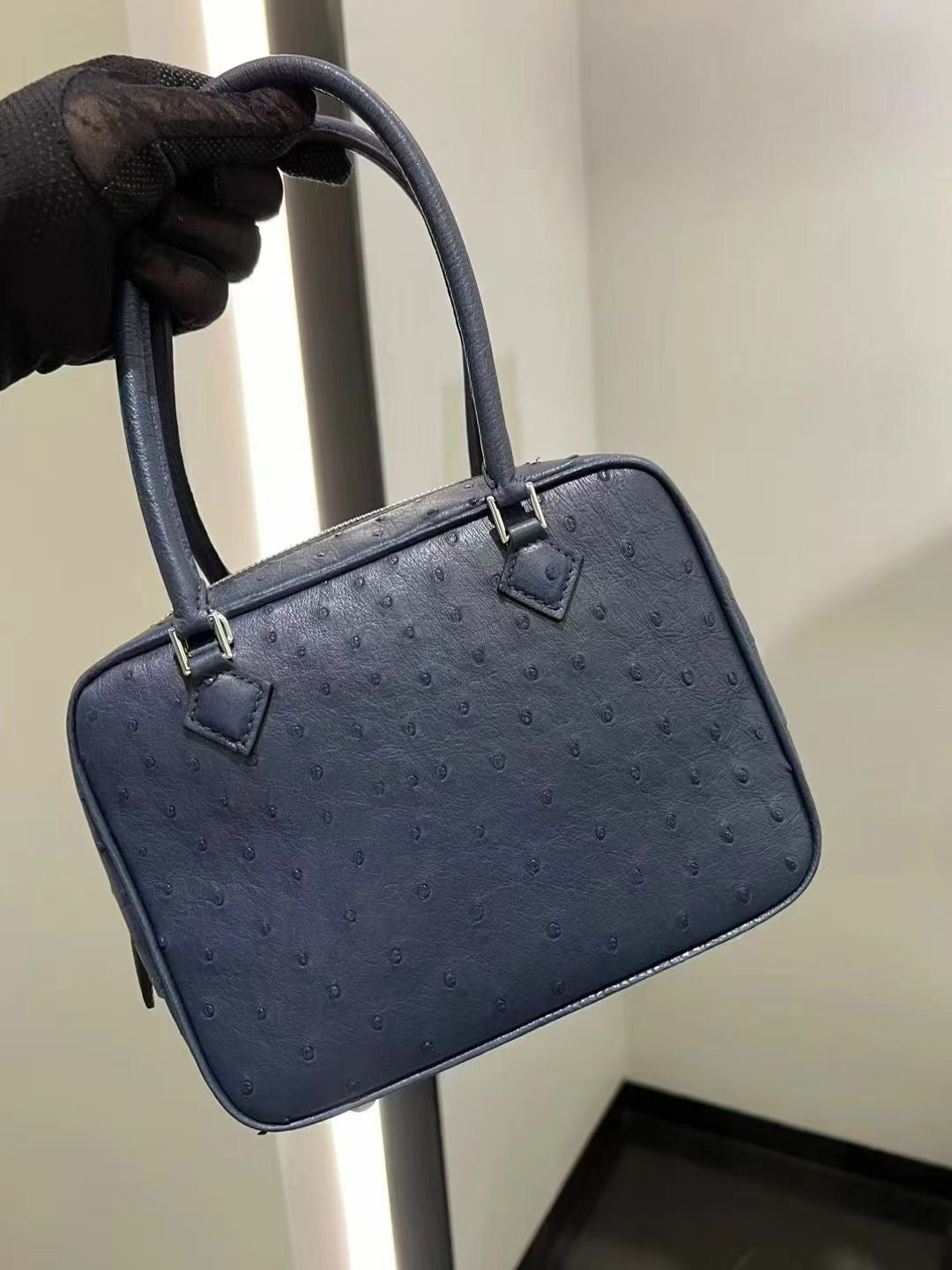 Women's genuine ostrich skin leather handbag with top handle by Rossie Viren, featuring a sleek and stylish design.