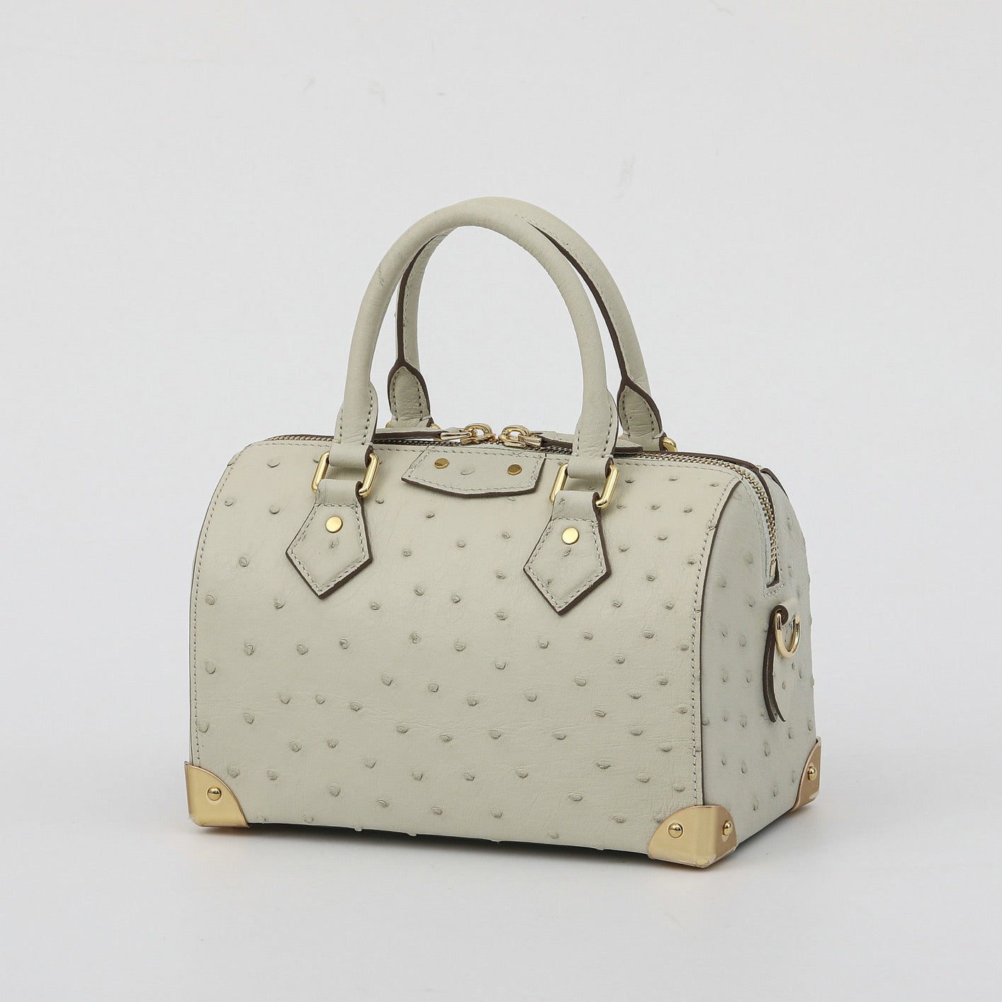 Women's genuine ostrich skin leather top handle pillow handbag by Rossie Viren, featuring a sleek, textured design with a top handle.