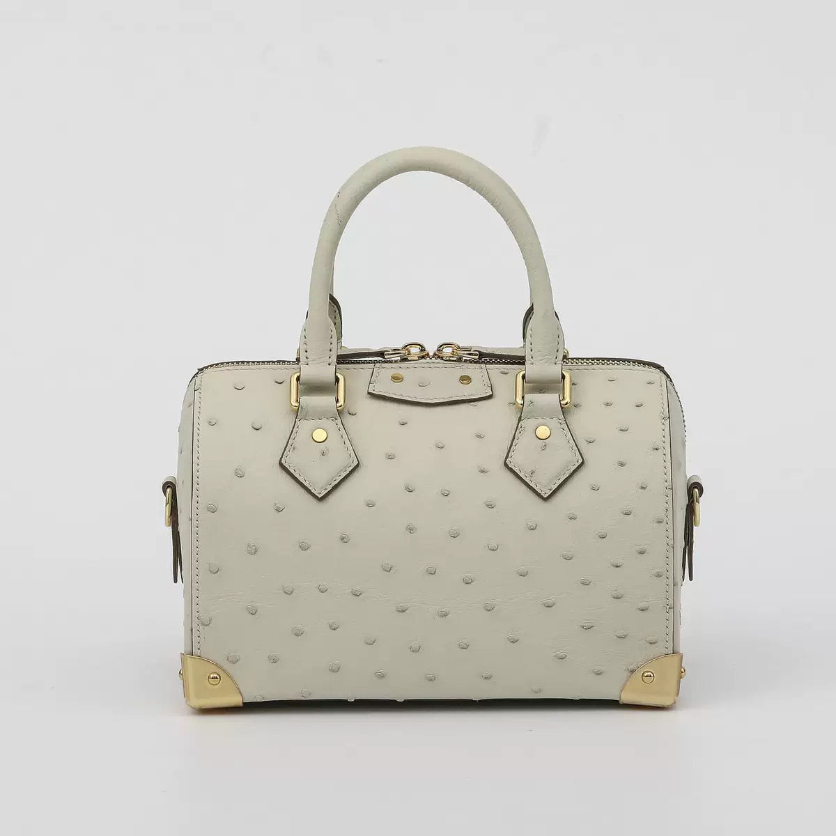Women's genuine ostrich skin leather handbag with top handle and pillow design by Rossie Viren.