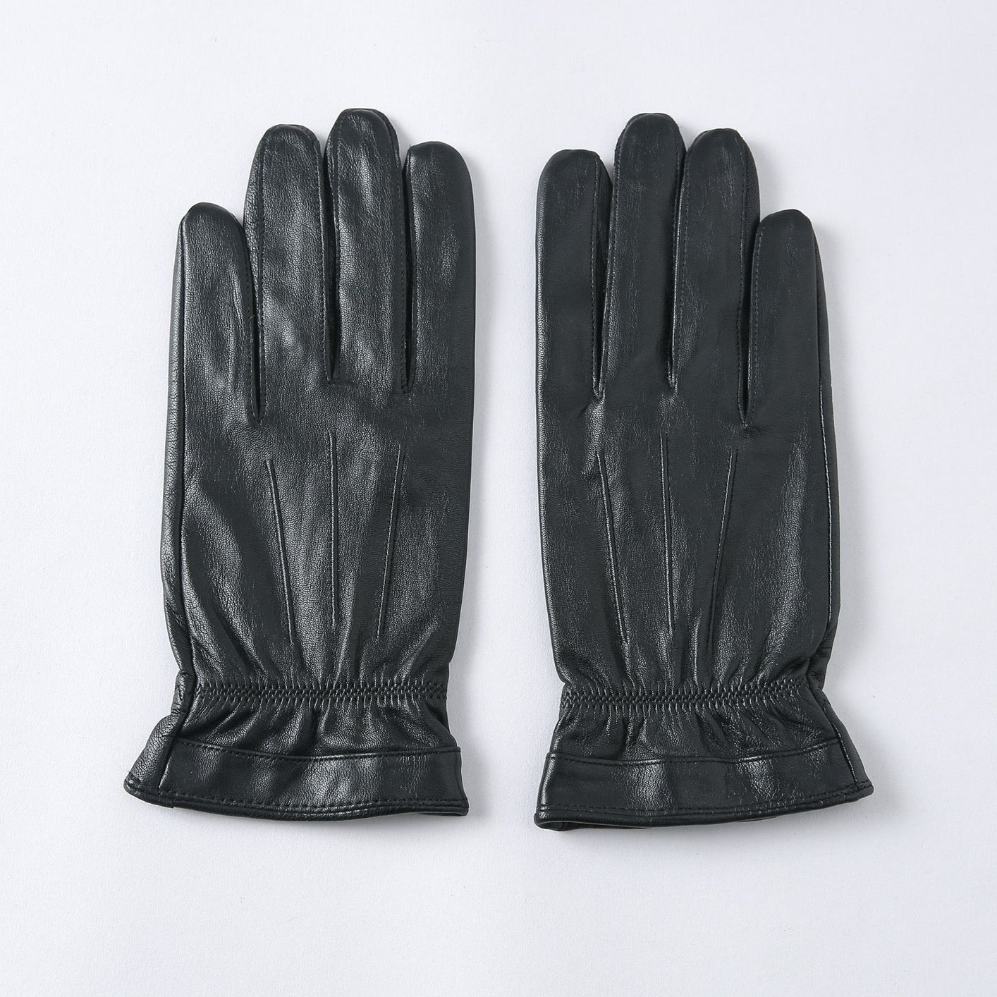 Black men's leather gloves from Rossie Viren, stylish handbag with smooth leather finish, perfect for cold weather.