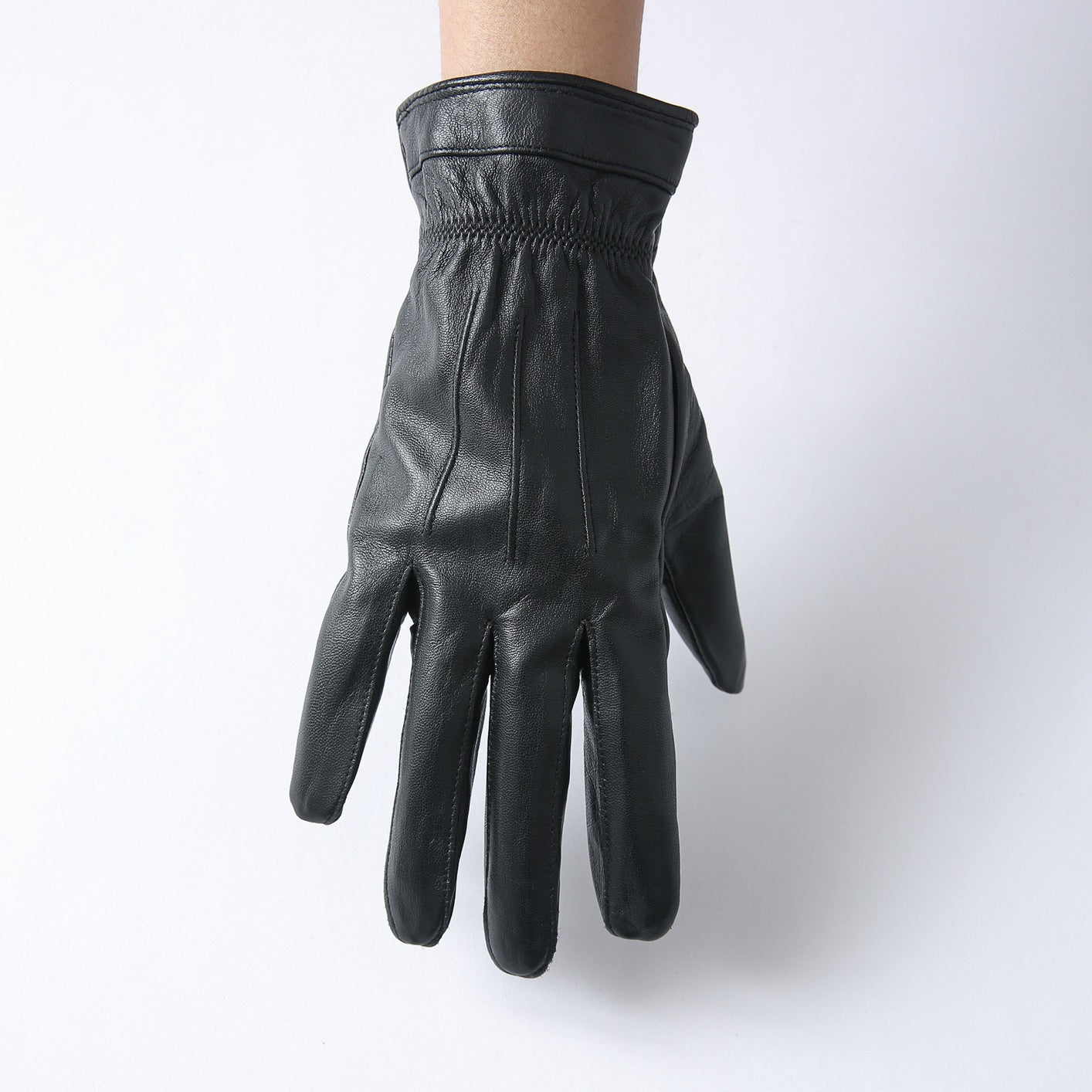 Black men's leather gloves by Rossie Viren, shown with a stylish handbag in the image.