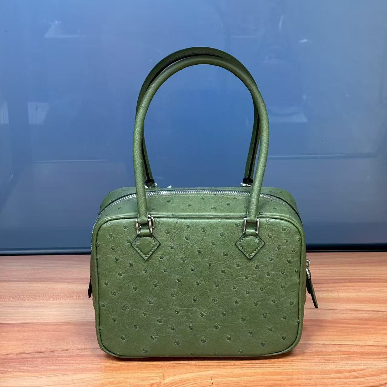 Women's genuine ostrich skin leather handbag with top handle by Rossie Viren, showcasing its textured surface and elegant design.