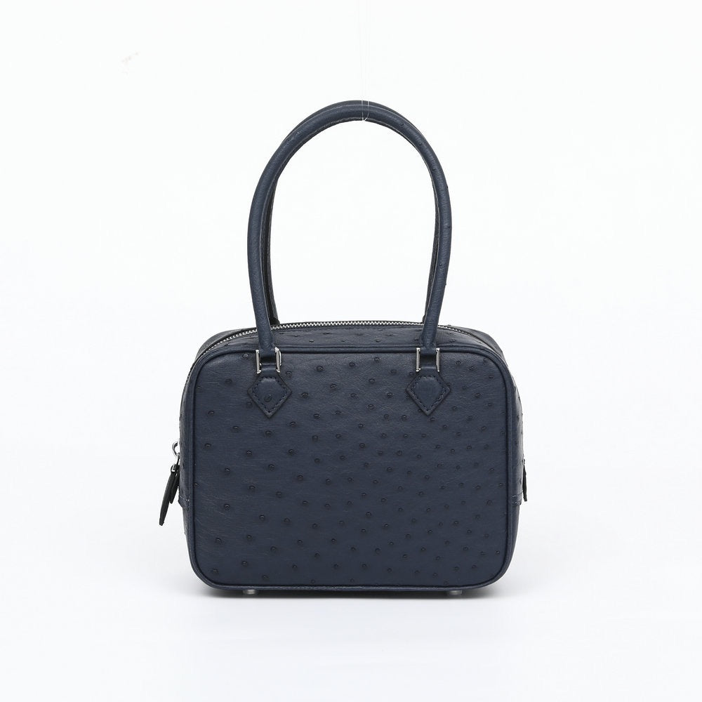 Women's genuine ostrich skin leather handbag with top handle from Rossie Viren, showcasing a luxurious textured surface and elegant design.