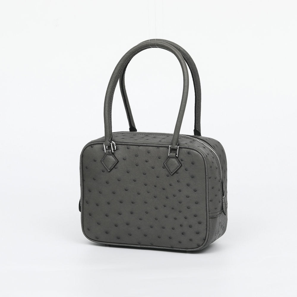 Women's genuine ostrich skin leather handbag with top handle by Rossie Viren, showing its textured surface and elegant design.