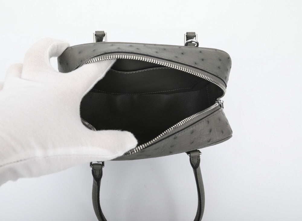 Women's genuine ostrich skin leather handbag with top handle by Rossie Viren, showcasing the textured leather and elegant design.