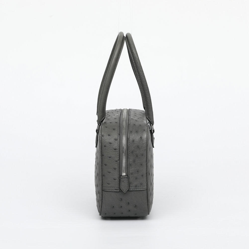 Women's genuine ostrich skin leather handbag with top handle, stylish Rossie Viren designer purse on white background.