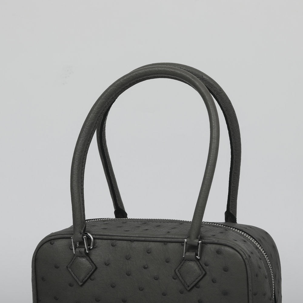Women's genuine ostrich skin leather handbag with top handle by Rossie Viren, featuring a sleek and stylish design.