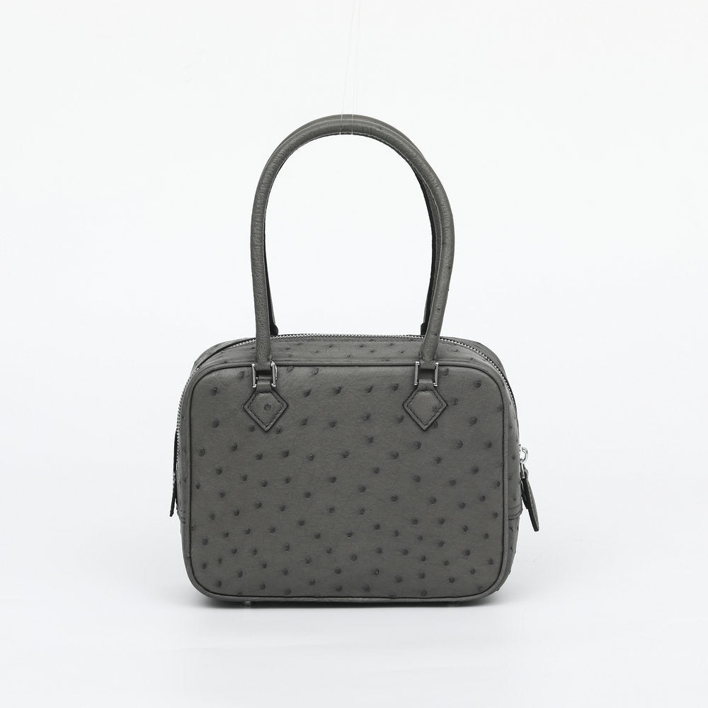 Women's genuine ostrich skin leather handbag with a top handle by Rossie Viren, showcasing its textured leather and elegant design.