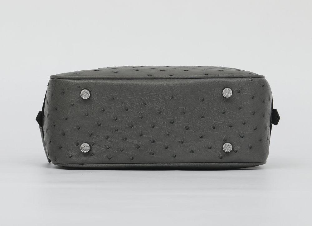 Women's genuine ostrich skin leather handbag with top handle by Rossie Viren, featuring a sleek, textured design and polished finish.