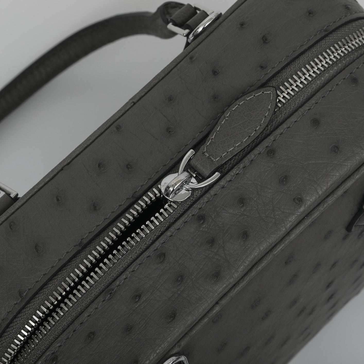 Women's genuine ostrich skin leather handbag with top handle by Rossie Viren, showcasing textured black leather and elegant design.