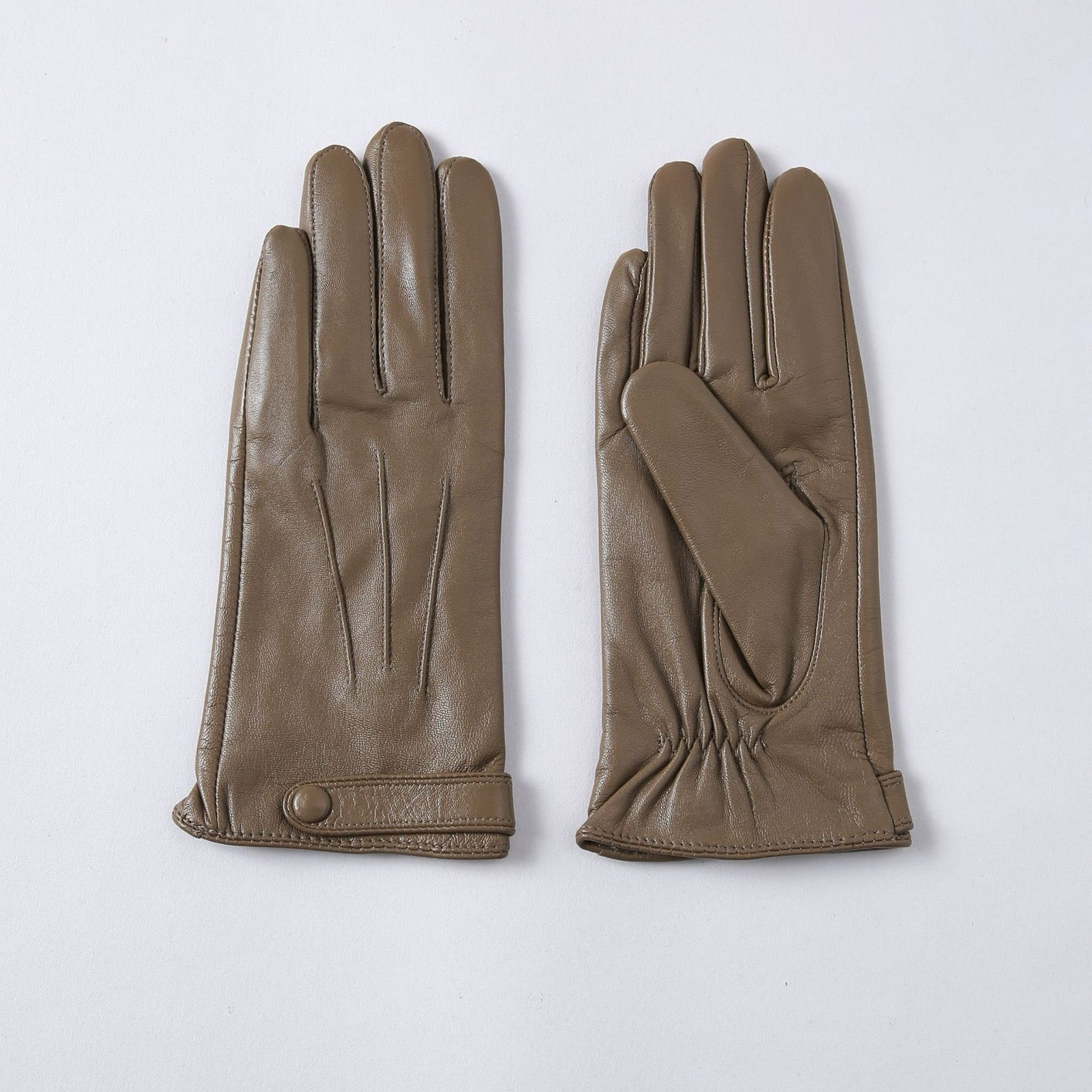 Women's soft goatskin leather fashion snap cuff gloves, stylish and warm, featuring a sleek design with metal snap details.