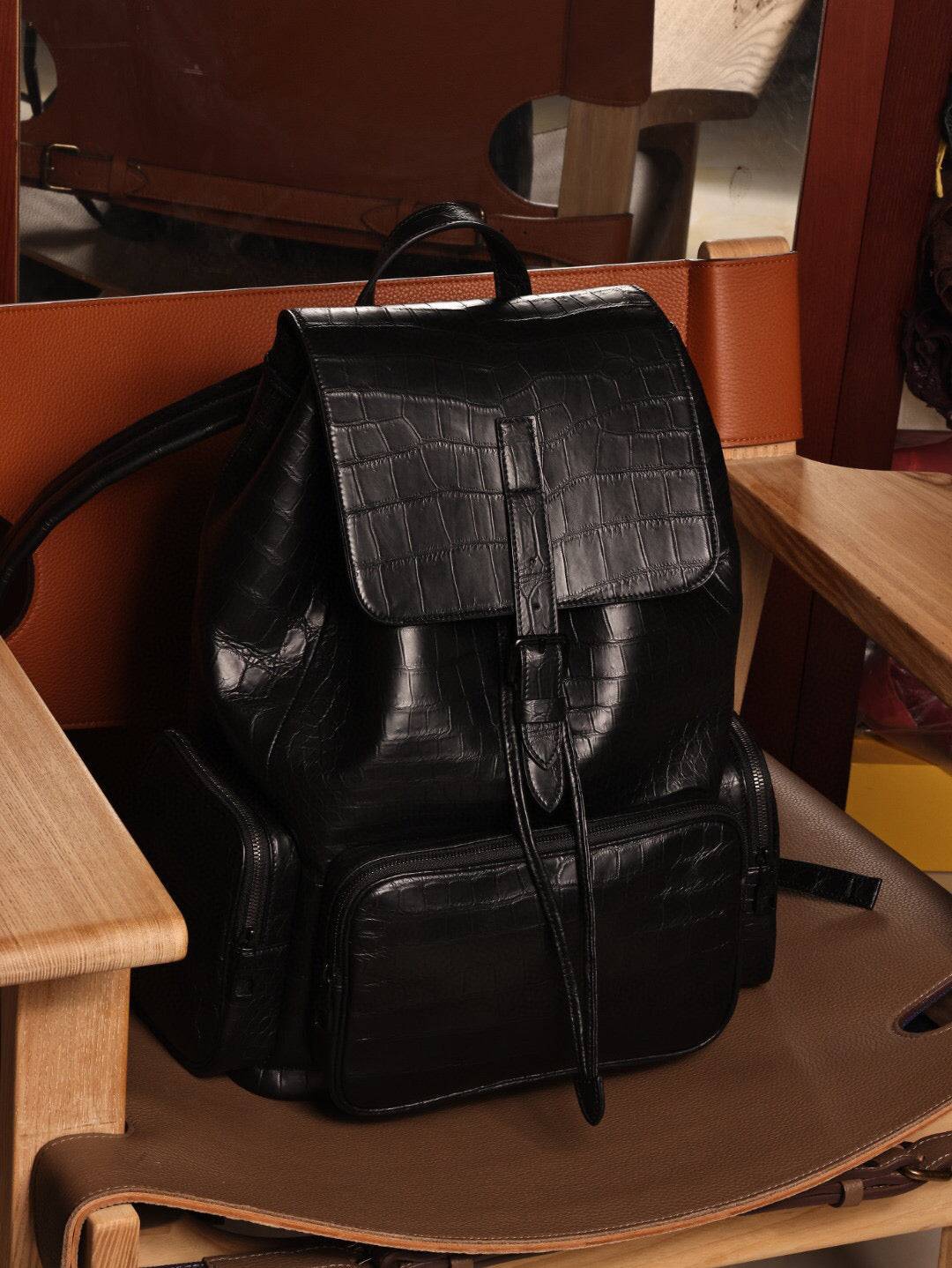 Unisex black crocodile leather backpack handbag by Rossie Viren with sleek design and textured crocodile pattern.