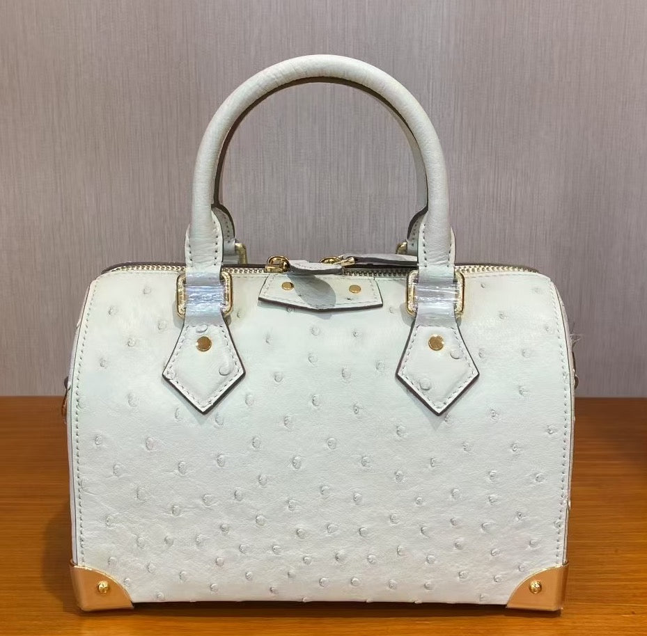 Women’s genuine ostrich skin leather top handle pillow handbag by Rossie Viren, showcasing its textured ostrich pattern and elegant design.