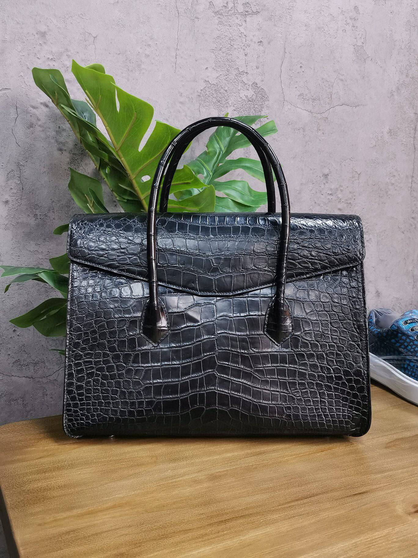Rossie Viren crocodile skin leather briefcase with sturdy handle and sleek design, ideal for business and professional use.