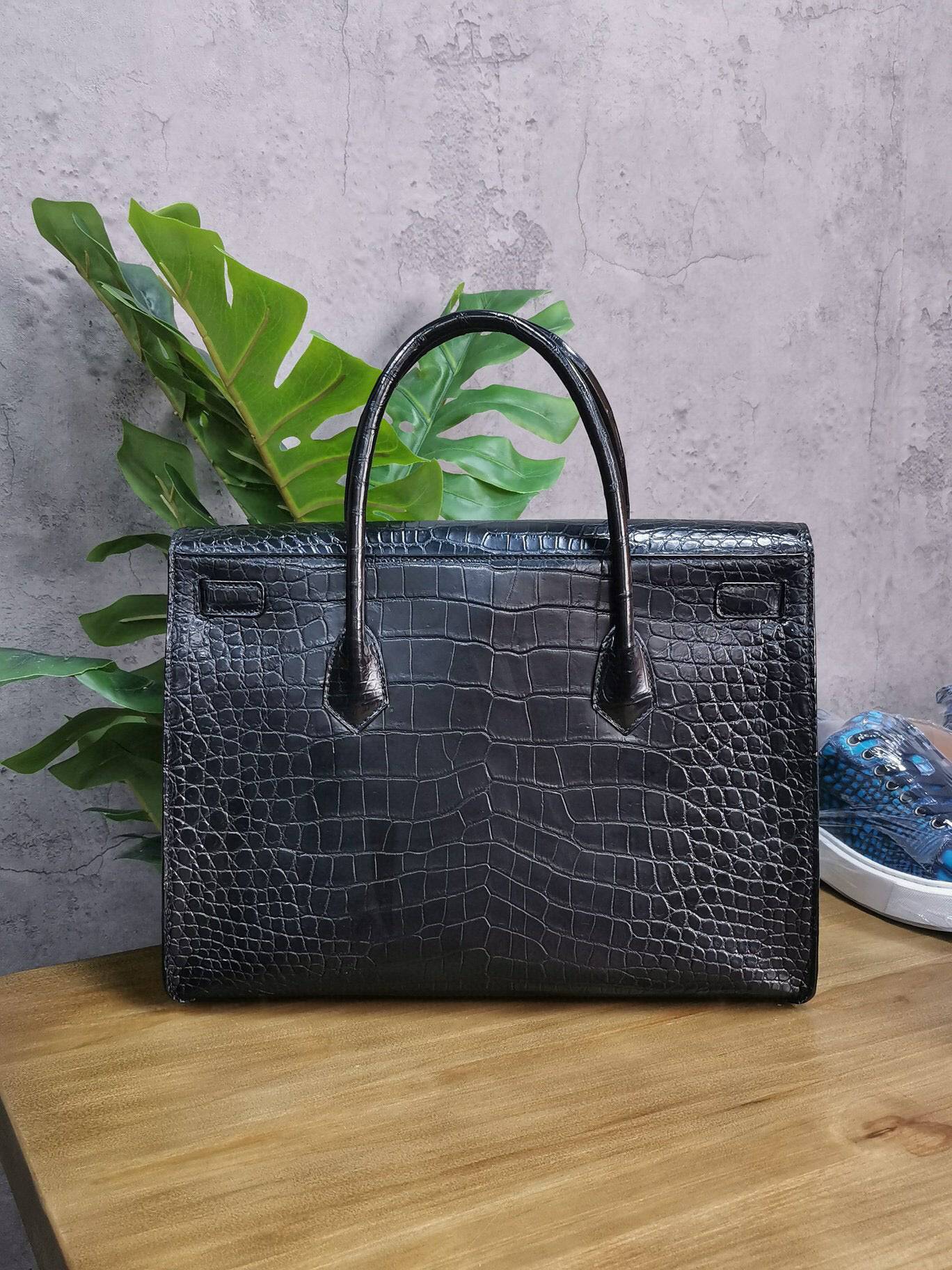 Rossie Viren crocodile skin leather briefcase with sturdy handle and sleek design, ideal for business and professional use.