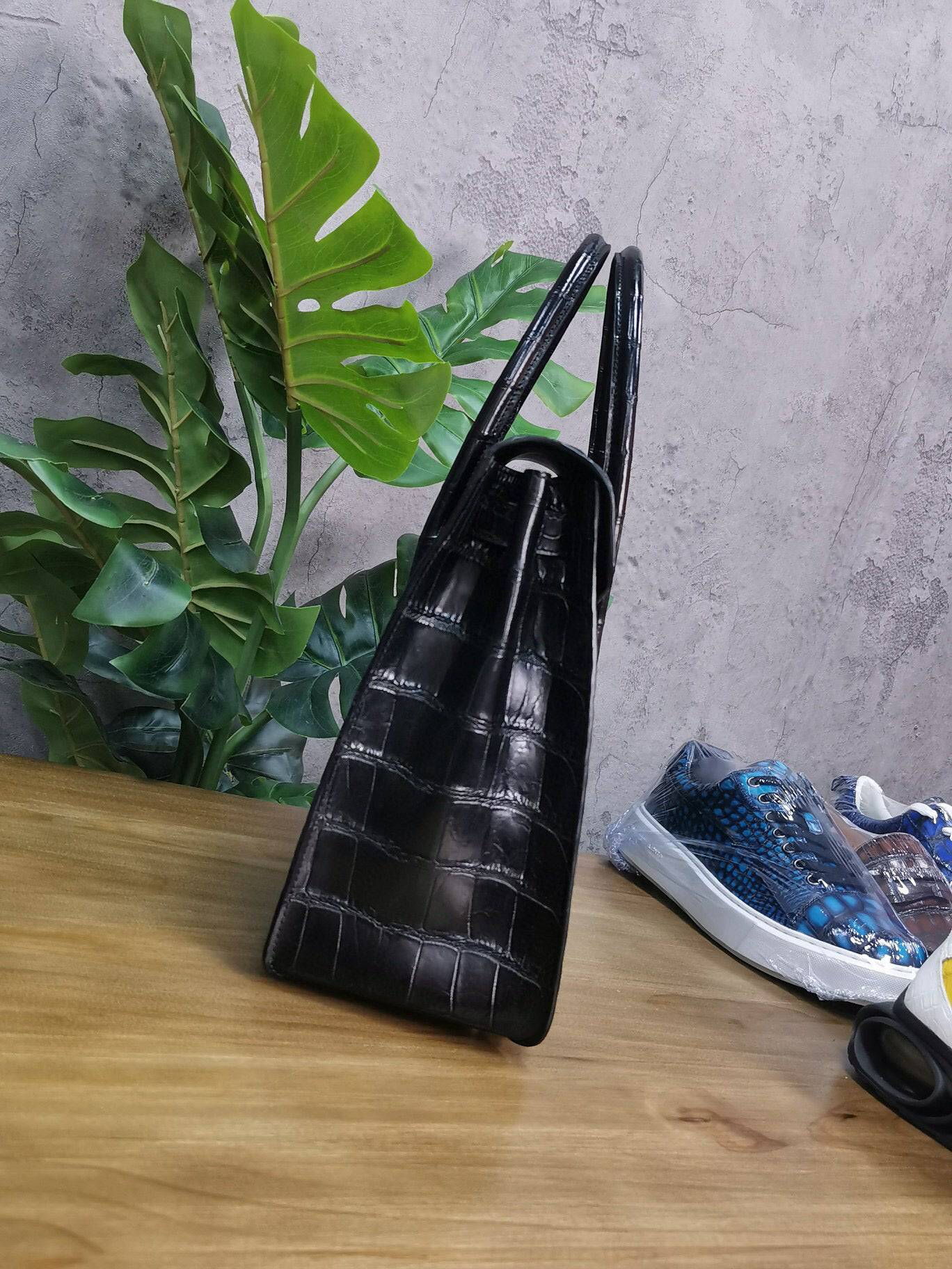 Rossie Viren crocodile leather briefcase with handles, showcasing its textured crocodile skin design and professional laptop storage.