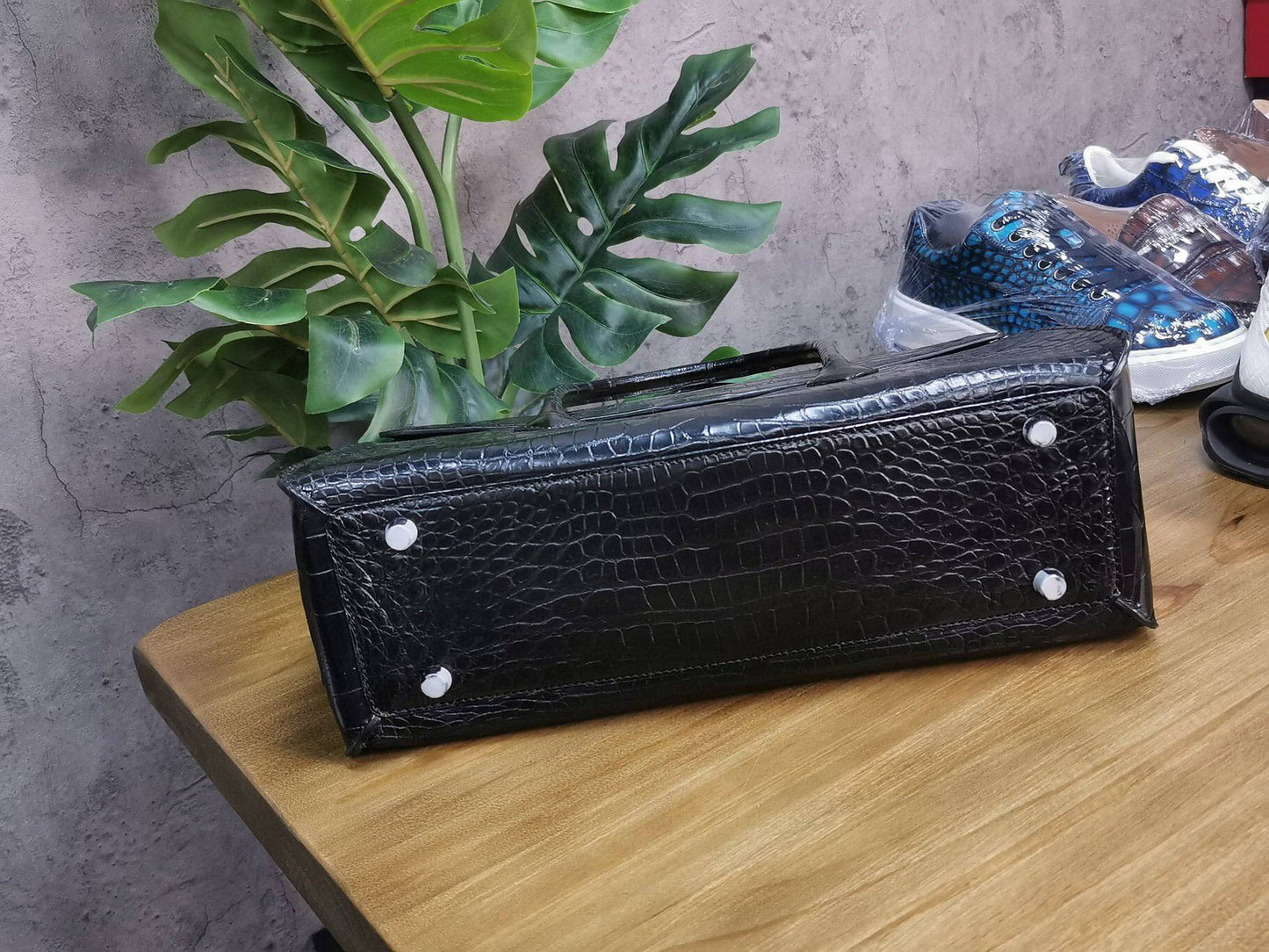 Rossie Viren crocodile skin leather briefcase with sturdy handles and sleek design, perfect for business and laptop storage.