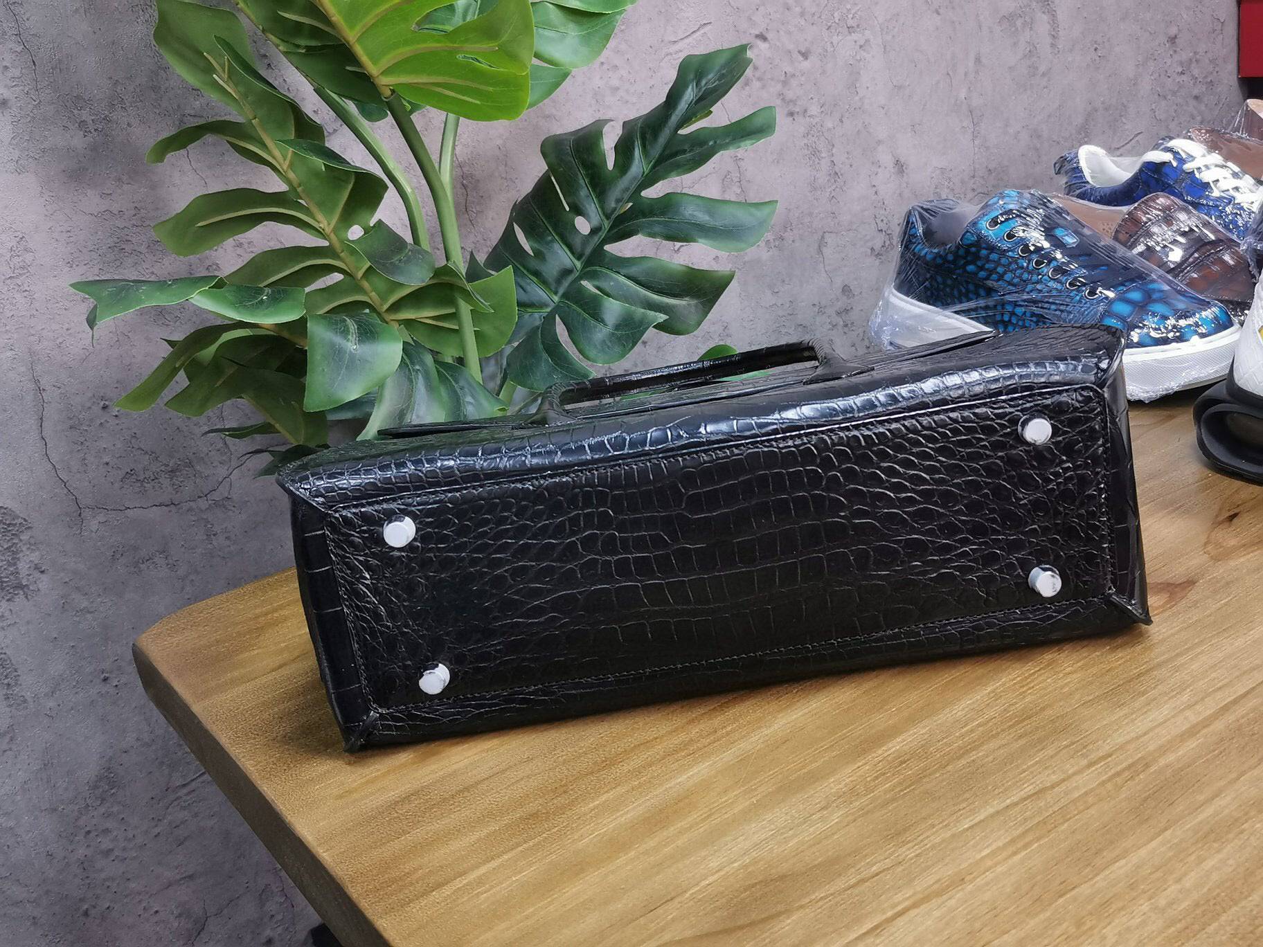 Rossie Viren crocodile skin leather briefcase with sturdy handles and sleek design, perfect for business and laptop storage.