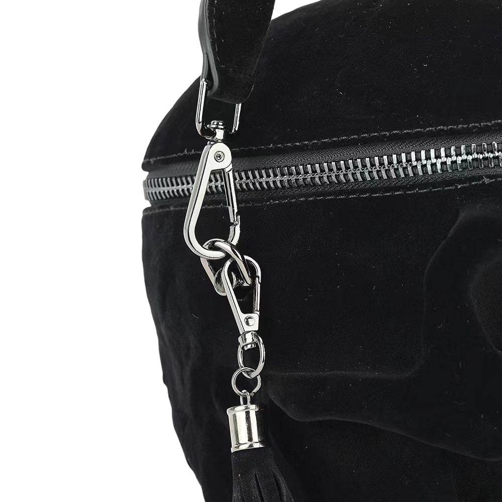 Black suede 3D skull crossbody handle bag with mini handle by Rossie Viren, featuring a sleek compact design and detailed skull embellishment.