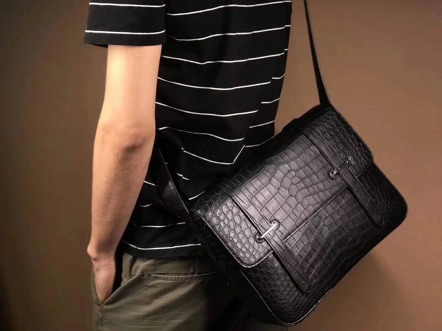Matt washed genuine crocodile leather messenger bag by Rossie Viren, featuring a stylish shoulder strap and classic postman design.