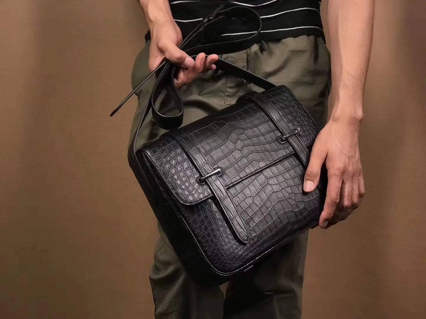 Matt washed genuine crocodile leather messenger handbag by Rossie Viren, featuring a sleek shoulder strap and stylish postman design.