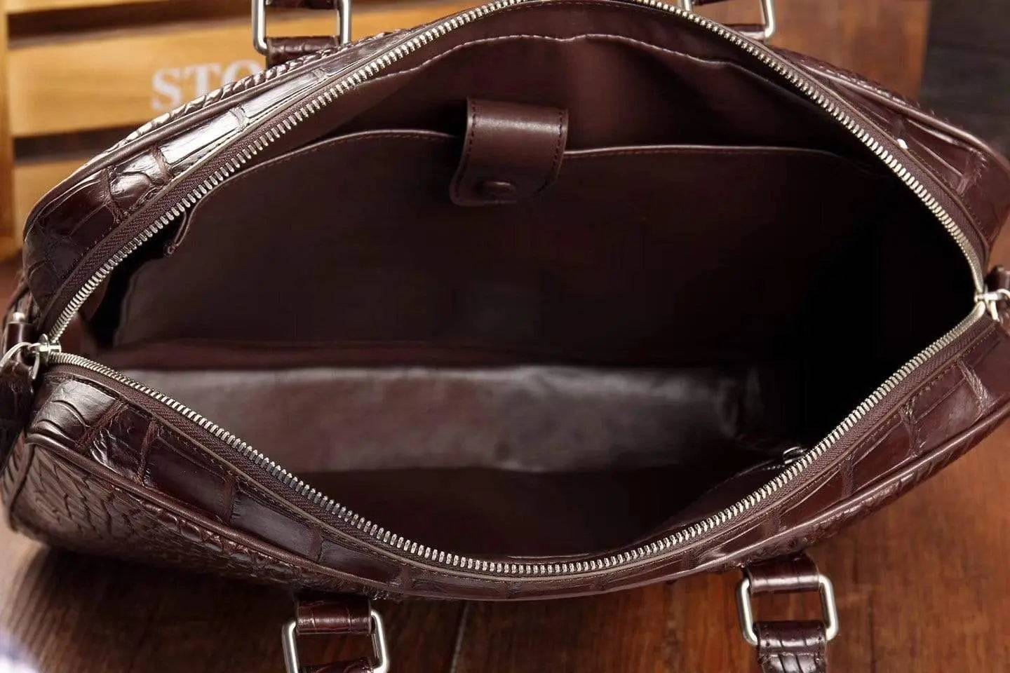 Men's crocodile leather briefcase with messenger and laptop bag design, featuring a sleek, structured handbag style.
